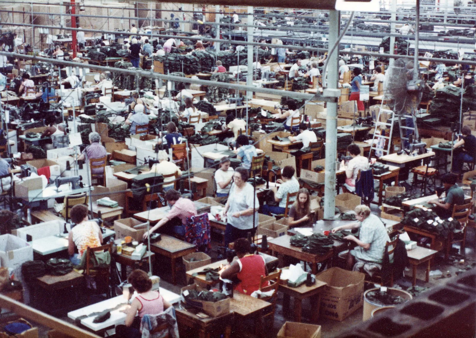 The sewing floor of a garment factory, rows of machine operators at work