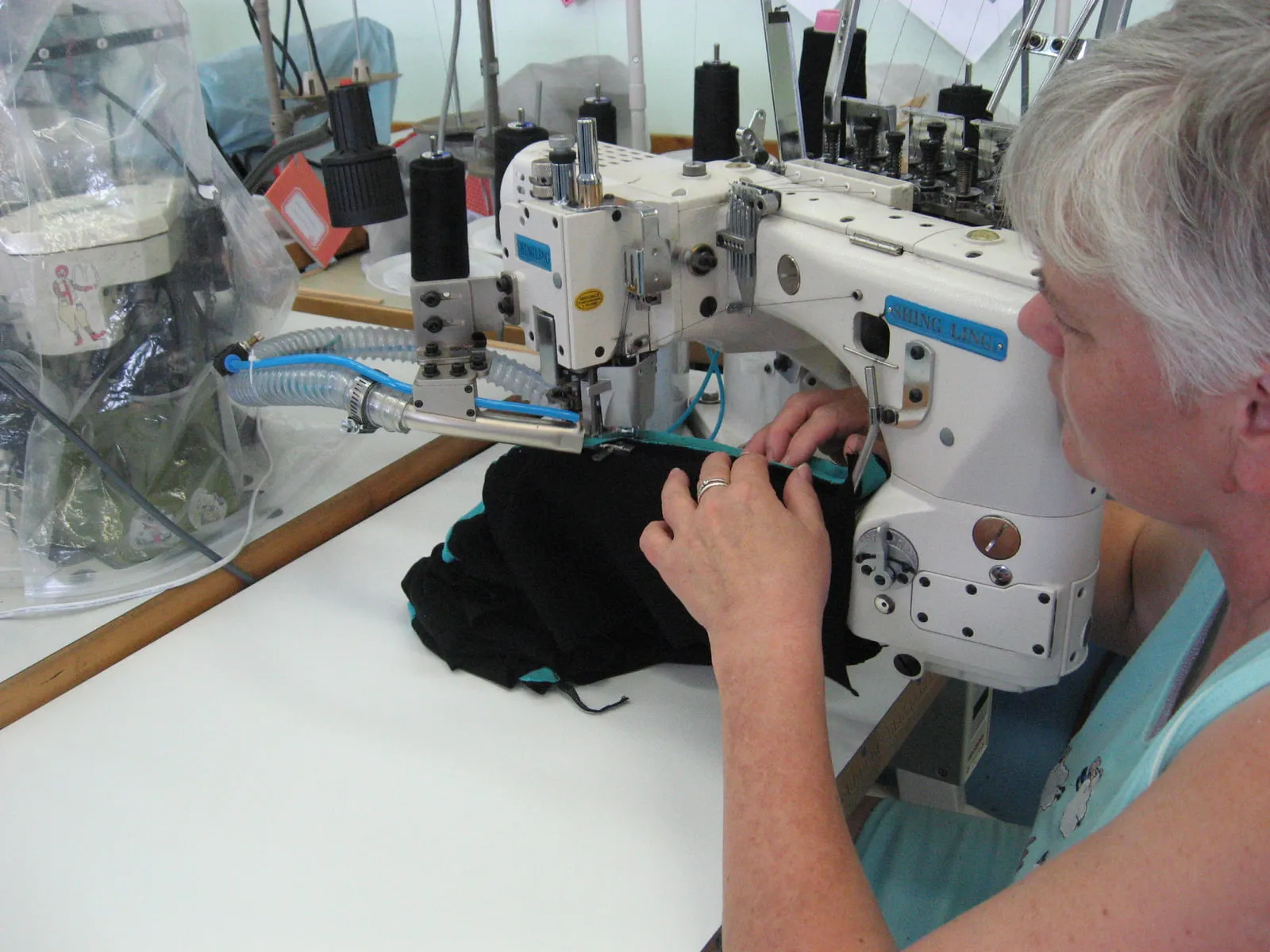 A sewing machine operator at work in a garment factory